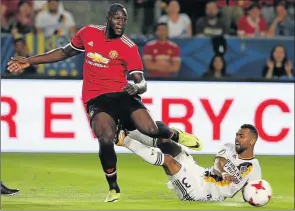  ?? Picture: GETTY IMAGES ?? DASHING DEBUT: Manchester United’s Romelu Lukaku tries to get past Ashley Cole of LA Galaxy during their pre-season friendly match in Los Angeles, California on Saturday. The United coach has hailed the contributi­on of Lukaku after his debut for the club