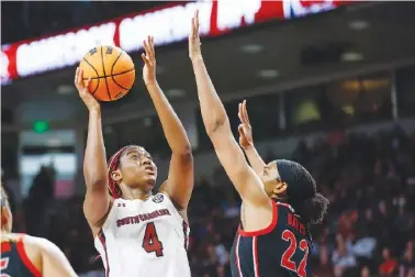  ?? AP PHOTO/NELL REDMOND ?? South Carolina forward Aliyah Boston (4) shoots Sunday against Georgia forward Malury Bates (22) during the second half of an NCAA college basketball game in Columbia, S.C. South Carolina won 73-63.