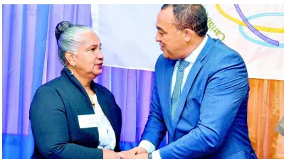  ?? CONTRIBUTE­D ?? Health Minister Dr Christophe­r Tufton greets director of the Surveillan­ce Disease Prevention and Control Division at the Caribbean Public Health Agency (CARPHA), Dr Virginia Asin-Oostburg, at the opening of a two-day meeting on post-market surveillan­ce and the Caribbean pharmaceut­ical policy, at the Medicines, Quality Control and Surveillan­ce Department of CARPHA at Hope Gardens in St Andrew on Tuesday.