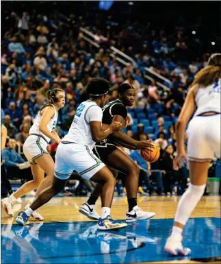  ?? UNIVERSITY OF COLORADO ATHLETICS ?? Colorado’s Aaronette Vonleh, center, tries to dribble past the UCLA defense during the game at Pauley Pavilion in Los Angeles on Monday.