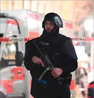  ?? Picture: Boris Roessler ?? A police officer stands guard near the crime scene in front of a restaurant in central Hanau, Germany. A gunman shot and killed nine people at several locations in what is being described as an act of domestic terrorism