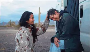  ?? Associated Press ?? Director Chloe Zhao, left, appears with actress Frances McDormand on the set of “Nomadland.”