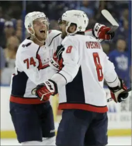  ?? CHRIS O’MEARA — THE ASSOCIATED PRESS ?? Washington’s Alex Ovechkin (8) celebrates his goal against the Lightning with defenseman John Carlson (74) during the first period Game 1 of the Eastern Conference finals Friday in Tampa, Fla. of