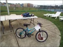  ?? TYLER RIGG — THE NEWS-HERALD ?? This bicycle, along with the items on the table, were raffle prizes provided by Target at Willoughby’s National Night Out on Aug. 13.