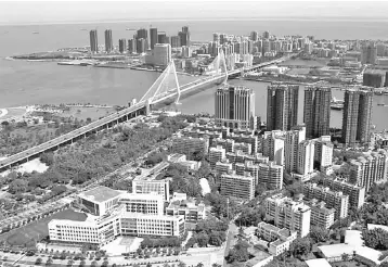  ??  ?? The Haikou Century Bridge connecting Haidian Island and the main Haikou area is pictured in Haikou, Hainan district, China. — Reuters photo