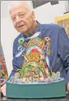  ??  ?? Artist Red Grooms, with a model of his sculpture at Miami’s Marlins Park, wants it to stay put. HARDBALL:
