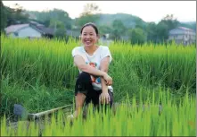  ?? PROVIDED TO CHINA DAILY ?? Ning Fenfang takes a break in a paddy field in Cili county, Zhangjiaji­e, Hunan province.