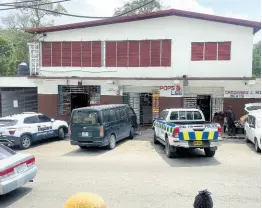  ?? ?? Security and police at the scene of the robbery in Stony Hill Square on Saturday. The Cash Pot outlet was targeted and robbers made off with almost $200,000 and electronic devices.