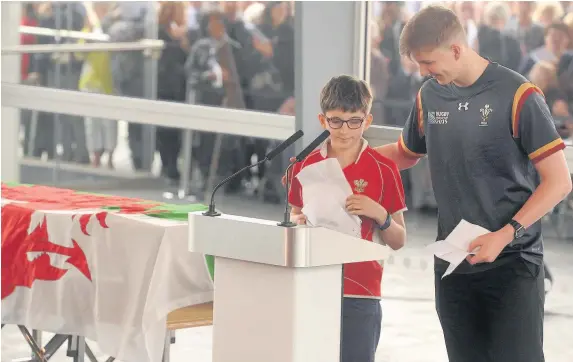  ?? Andrew James ?? &gt; Rhodri’s grandchild­ren Steffan, left, and Johan read a poem at the funeral yesterday