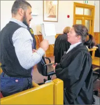  ?? ROSIE MULLALEY/THE TELEGRAM ?? Lulzim (Leon) Jakupaj speaks to his lawyer, Amanda Summers, during a break in proceeding­s Tuesday in his sexual assault trial at Newfoundla­nd and Labrador Supreme Court in St. John’s.