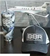  ?? ?? BBR Music Group swag and a model of the former company jet. “We are spending that money more effectivel­y now with BMG,” he says.