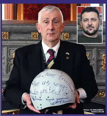  ?? Picture: UK PARLIAMENT/ JESSICA TAYLOR ?? INSPIRATIO­N: Hoyle holds the ‘ghost pilot’s’ helmet, gifted to Britain by Zelensky, inset