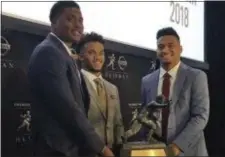  ?? RALPH RUSSO — THE ASSOCIATED PRESS ?? Heisman Trophy finalists, from left, Dwayne Haskins, from Ohio State, Kyler Murray, of Oklahoma, and Tua Tagovailoa, from Alabama, pose with the Heisman Trophy at the New York Stock Exchange on Friday in New York.