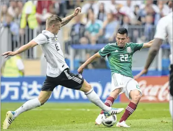  ??  ?? Mexico’s forward Hirving Lozano (C) shoots and scores the winner against Germany at the Luzhniki Stadium in Moscow on Sunday.