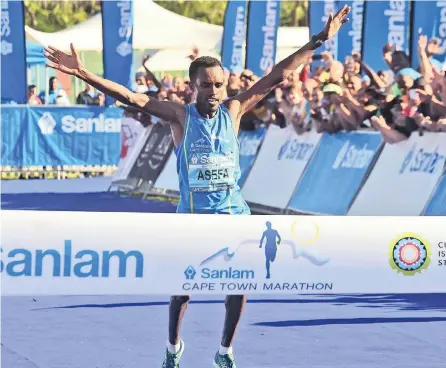  ?? PICTURE: PHANDO JIKELO ?? BLUE RIBBON: Asefa Mengistu Negewo successful­ly defended his Cape Town Marathon title, winning the race in 2:10.01.