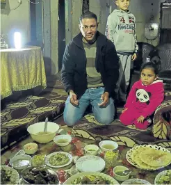  ??  ?? Sharing a meal with Shadi and his family in their home in a refugee camp