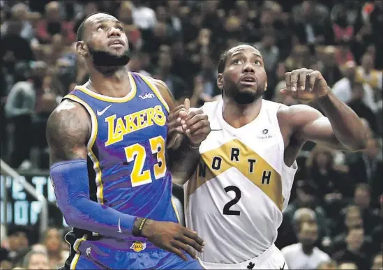  ?? Vaughn Ridley Getty Images ?? LeBRON JAMES, the biggest star in L.A. last season, has a fight on his hands this season with Kawhi Leonard (2) joining the Clippers fresh off winning an NBA title.