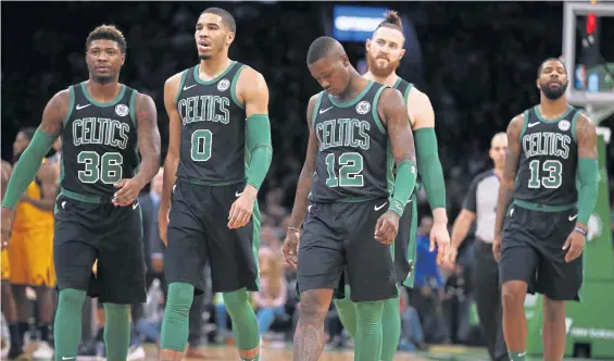  ?? ASSOCIATED PRESS ?? DOWNER: Marcus Smart, Jayson Tatum, Terry Rozier, Aron Baynes and Marcus Morris walk off the court during the Celtics’ loss Monday night.