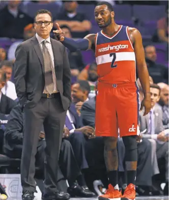  ?? MARK J. REBILAS, USA TODAY SPORTS ?? Led by coach Scott Brooks and John Wall, the Wizards hope to make noise in the playoffs.