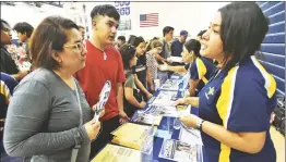  ?? Dan Watson/The Signal ?? College of the Canyons representa­tive Eva Alonzo-Ayon, right, talks to Cristina Padron, left, and Jacon Zepeda, 16, during the annual College and Career Fair, held at West Ranch High School on Sept. 17.