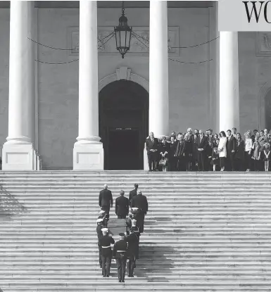  ?? SUSAN WALSH / AFP / GETTY IMAGES ?? The family of Rev. Billy Graham watches as his casket is carried up the steps of the U.S. Capitol, where Graham will lie in honour in the Rotunda. Graham received a rare tribute from U.S. political leaders Wednesday.