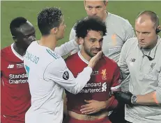  ??  ?? Real Madrid’s Cristiano Ronaldo consoles Liverpool’s Mo Salah.