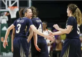  ?? LYNNE SLADKY — THE ASSOCIATED PRESS ?? Quinnipiac’s Adily Martucci (3) is congratula­ted by with Carly Fabbri after making a 3-point basket during the closing seconds against Miami in the second round of the NCAA women’s basketball tournament Monday.