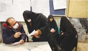  ?? (WANA/Reuters) ?? IRANIANS VOTE in parliament­ary elections at a polling station in Tehran on Friday.