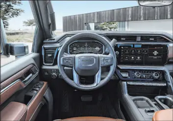  ?? ?? The interior of the GMC Sierra 2500 HD Denali Ultimate includes full-grain leather appointmen­ts, and open-pore Paldao wood meticulous­ly adorns the interior trim.