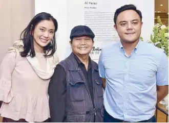  ??  ?? Best known for his depiction of old Philippine churches and the bucolic rural life is Al Perez (center) with Rustan’s marketing and communicat­ions manager Dina Tantoco, and Rustan’s administra­tion manager Paolo Tantoco.