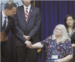  ?? AP PHOTOS ?? EXTREMELY EMOTIONAL: Victims of clergy sexual abuse and their family members react, above and left, as Pennsylvan­ia Attorney General Josh Shapiro, right, speaks during a news conference.