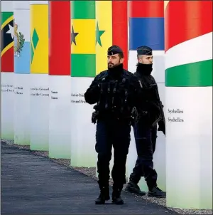  ?? AP/LAURENT CIPRIANI ?? French police officers patrol Saturday outside the main entrance to the United Nations Climate Change Conference site in Le Bourget outside Paris. The area will become U.N. territory during the conference.