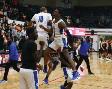  ?? DAVID C. TURBEN — FOR THE NEWS-HERALD ?? Richmond Heights rushes the court after a 46-43 win March 15 over New Middletown Springfiel­d in a Division IV regional final in Canton.