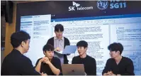  ?? SK Telecom ?? SK Telecom’s head of future R&D Lee Jong-min (second from right) and other team members hold a meeting.