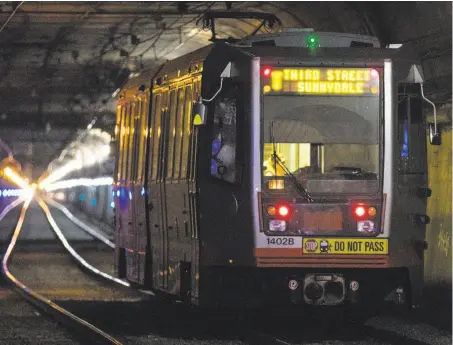  ?? Jessica Christian / The Chronicle ?? A T-Third train enters the Twin Peaks Tunnel at Forest Hill Station in June, shortly before the tunnel was closed for repairs.