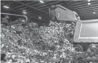  ??  ?? A City of Memphis truck dumps its load of recyclable­s at the Recommunit­y recycling facility off of Farrisview. BRAD VEST/THE COMMERCIAL APPEAL/FILE