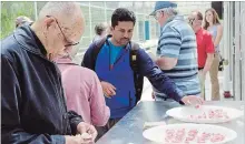  ?? LUKE EDWARDS METROLAND ?? Visitors to Vineland Research and Innovation Centre test a greenhouse tomato during tours of the facility’s greenhouse tomato program.