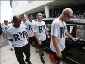  ?? WILFREDO LEE — THE ASSOCIATED PRESS ?? Somber Miami Marlins players, including Mike Donn (40), J.T. Realmuto (11) and Christian Yelich (21), walk alongside a hearse carrying the body of pitcher Jose Fernandez as it leaves Marlins Park stadium, Wednesday in Miami. Fernandez was killed in a...