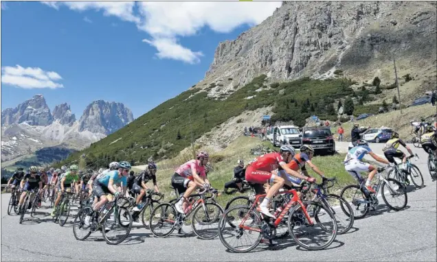  ??  ?? ESPECTÁCUL­O. El grupo con los más fuerte, con Tom Dumoulin vestido de rosa, toma una curva en una de las ascensione­s. El Movistar, en cabeza, pone el ritmo para Nairo.