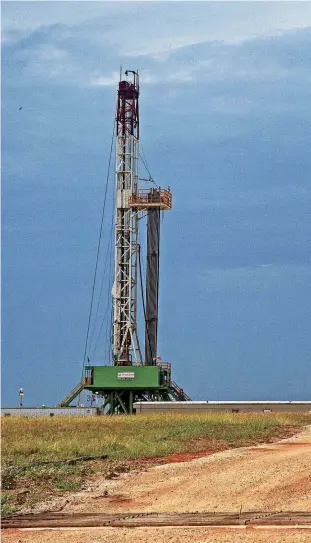  ?? [PHOTO BY CHRIS LANDSBERGE­R, THE OKLAHOMAN] ?? An oil rig drills near Kingfisher in the STACK play in July. The Oklahoma Energy Index for May shows the industry continued to grow.