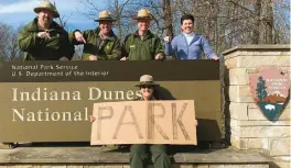  ?? PAUL LABOVITZ/INDIANA DUNES NATIONAL PARK ?? Workers with a homemade sign mark the nation’s 61st national park in February when the Indiana Dunes National Park became a reality.