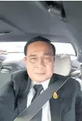  ??  ?? Prime Minister Prayut Chan-o-cha takes a selfie as he buckles up in a car and drives home the message of road safety.