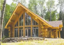  ??  ?? To truly appreciate the architectu­ral design of the cabin, one must go around to the side with large panoramic windows that faces the lake.