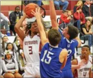  ?? THOMAS NASH - DIGITAL FIRST MEDIA ?? Pottsgrove’s Khaliym Smith (3) rises up to shoot over the defense of Great Valley’s Will Fredrick (15) and Nate Graeff (32) during the first half Tuesday night.