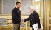  ?? AP ?? Ukrainian President Volodymyr Zelenskyy and U.S. Treasury Secretary Janet Yellen shake hands during their meeting in Kyiv, Ukraine, on Monday.