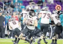  ?? WILLIE J. ALLEN JR. /ORLANDO SENTINEL ?? Northern Illinois quarterbac­k Rocky Lombardi rolls out to throw during the Cure Bowl against Coastal Carolina at Exploria Stadium on Friday night.