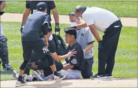  ?? ADAM HUNGER — THE ASSOCIATED PRESS ?? Yankees pitcher Masahiro Tanaka is tended to by team medical personnel after being hit by a ball off the bat of Giancarlo Stanton during a workout July 4 at Yankee Stadium.