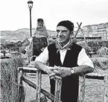  ??  ?? Giovanni Paruta, left, works at his butcher shop in Geraci Siculo, tucked into the Madonie Mountains. Rosario Restivo, a basket-maker, dresses as a traditiona­l mountain farmer at a wheat-making exhibit in Gangi.