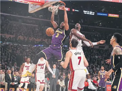  ??  ?? The Lakers’ Anthony Davis dunks the ball against the Heat in Los Angeles.