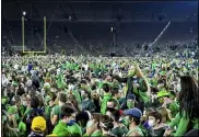  ?? MATT CASHORE — POOL PHOTO VIA AP ?? Fans storm the field after Notre Dame defeated the Clemson 47-40 in two overtimes in an NCAA college football game Saturday, Nov. 7, in South Bend, Ind.